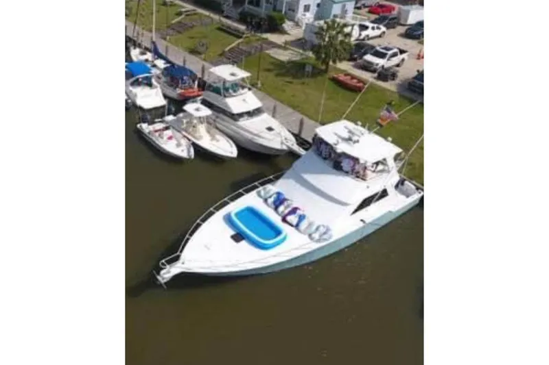 Slide: The Image of Aerial view of 1994 Breaux Bay Craft 58 Sportfish yacht docked with inflatable pool. - 4