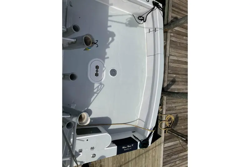 Slide: The Image of 1994 Breaux Bay Craft 58 Sportfish boat deck with fishing rod holders and dock. - 6