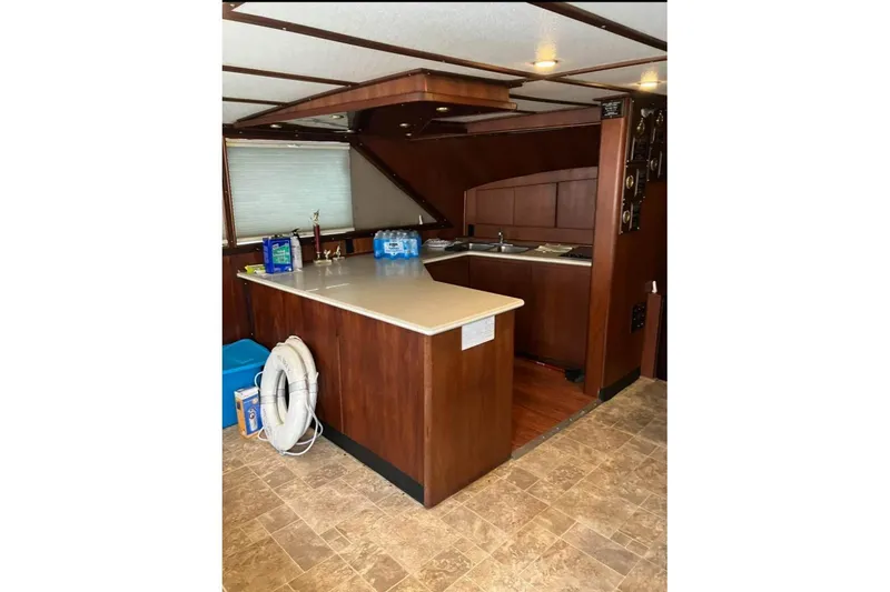 Slide: The Image of Interior of 1994 Breaux Bay Craft 58 Sportfish with wooden cabinetry and kitchen area. - 7