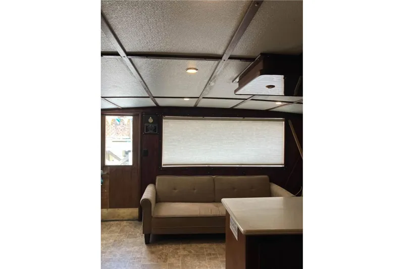 Slide: The Image of Interior of 1994 Breaux Bay Craft 58 Sportfish with sofa and window blinds. - 9