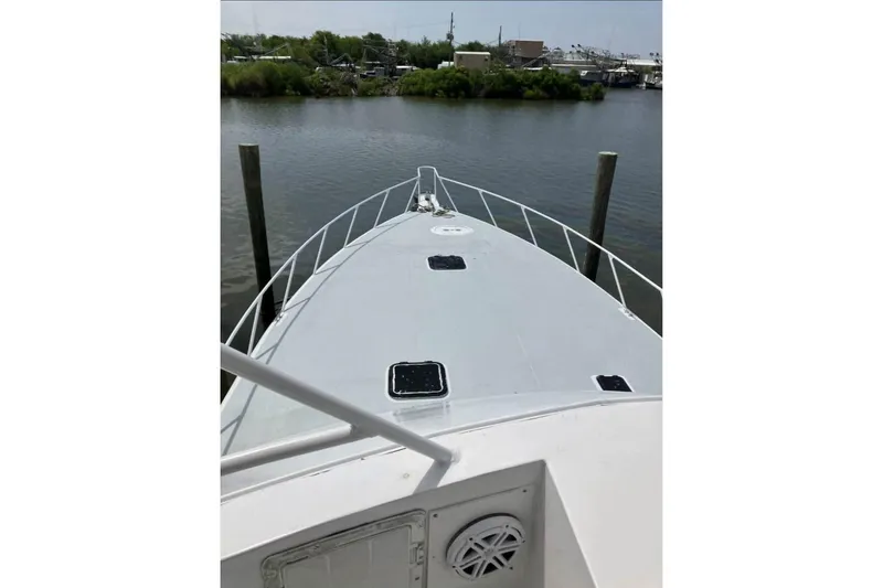 Slide: The Image of Bow view of 1994 Breaux Bay Craft 58 Sportfish on calm water. - 5