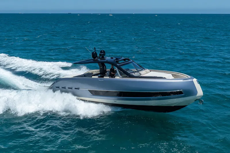 Slide: The Image of 2024 Invictus 460 yacht cruising on open sea, showcasing sleek design and performance. - 12