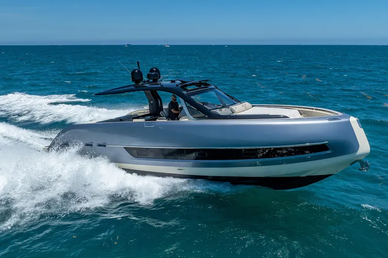 Slide: The Image of 2024 Invictus 460 yacht cruising on open sea under clear blue sky. - 13