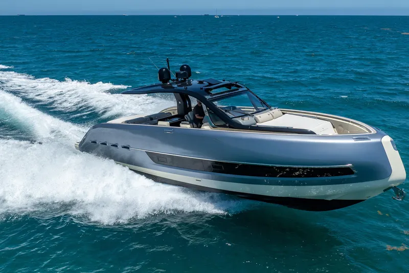 Slide: The Image of 2024 Invictus 460 yacht cruising on open blue sea. - 14