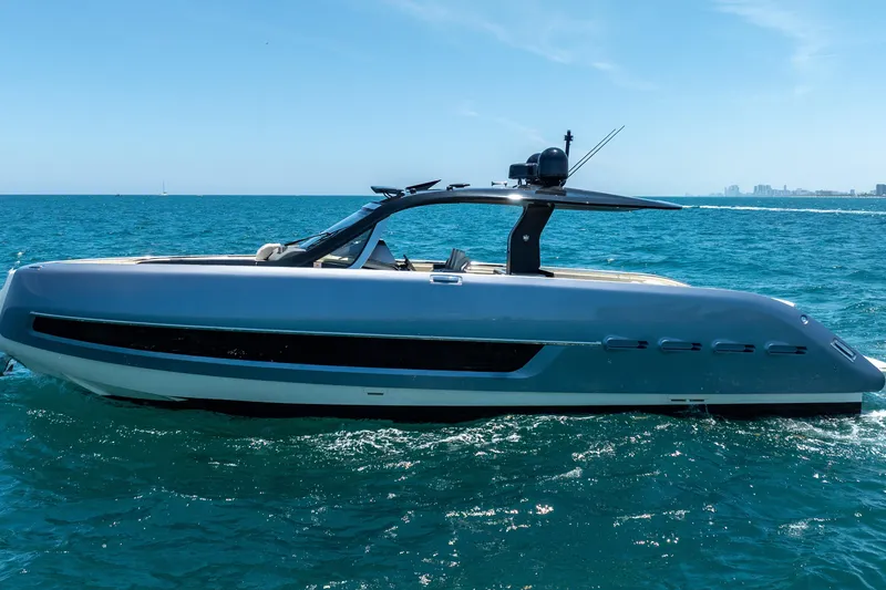 Slide: The Image of 2024 Invictus 460 yacht cruising on blue ocean waters under clear skies. - 2