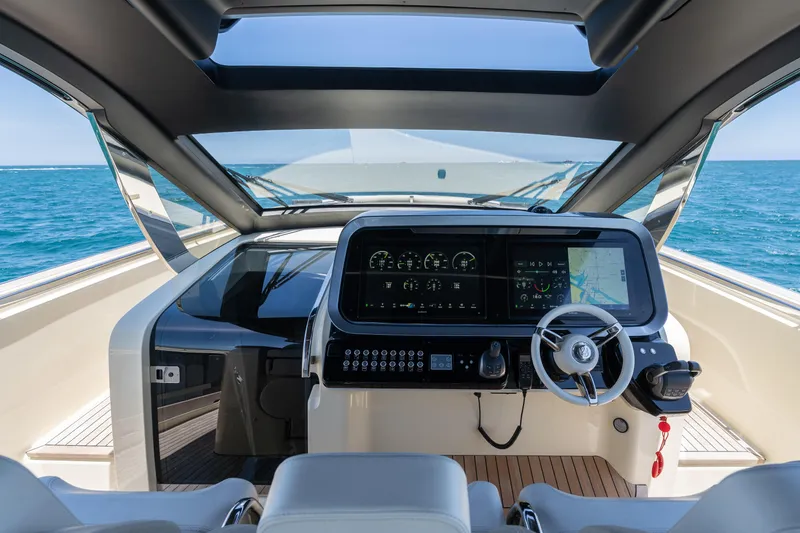 Slide: The Image of 2024 Invictus 460 yacht cockpit with modern navigation system and ocean view. - 23
