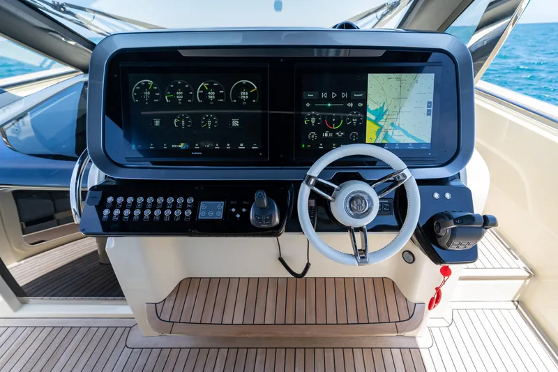 Slide: The Image of 2024 Invictus 460 yacht helm with advanced navigation displays and controls. - 24