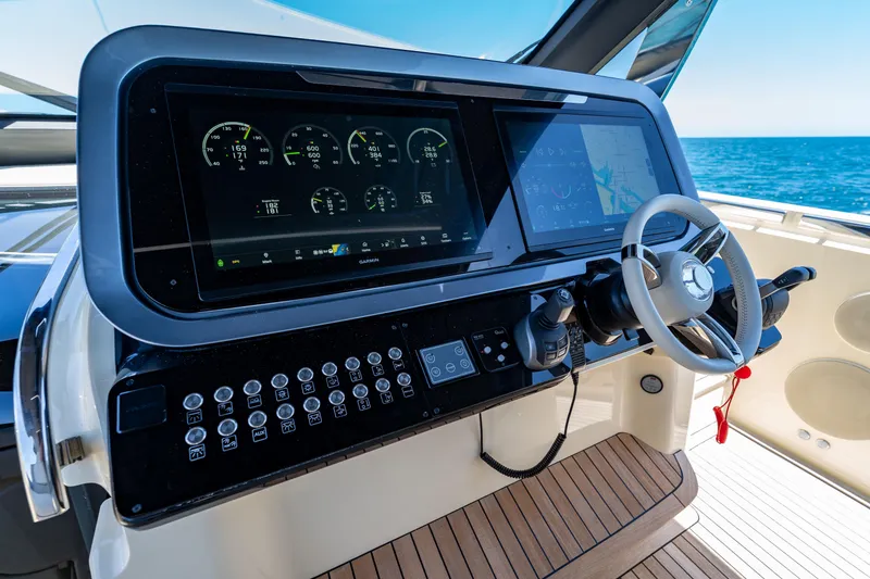 Slide: The Image of 2024 Invictus 460 yacht helm with advanced navigation displays and controls. - 25
