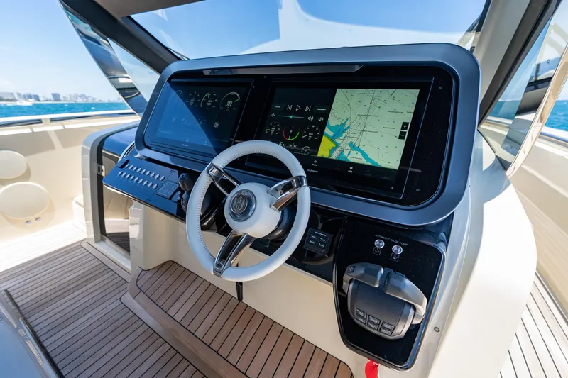 Slide: The Image of Helm of 2024 Invictus 460 yacht with modern navigation displays and steering wheel. - 26