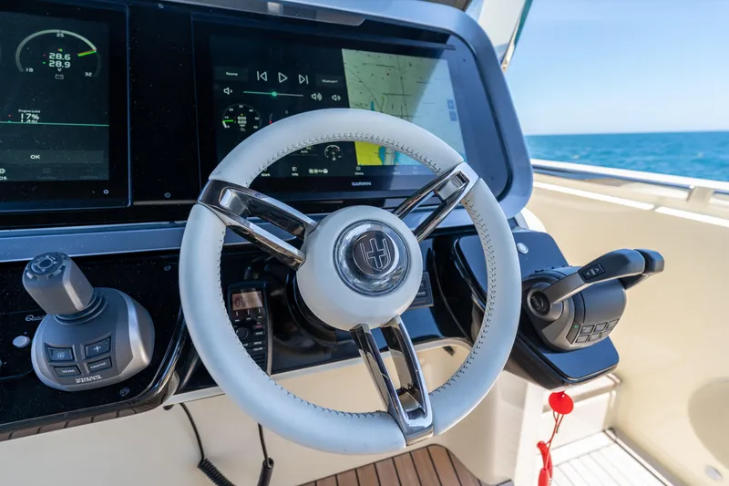 Slide: The Image of 2024 Invictus 460 yacht helm with modern controls and navigation screens. - 27