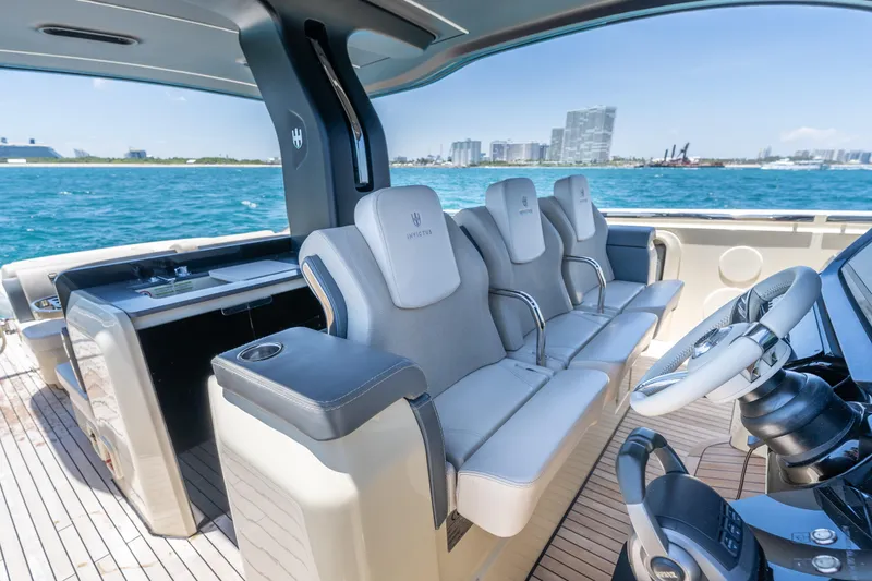 Slide: The Image of Luxurious seating and helm of 2024 Invictus 460 yacht, with ocean and cityscape views. - 30