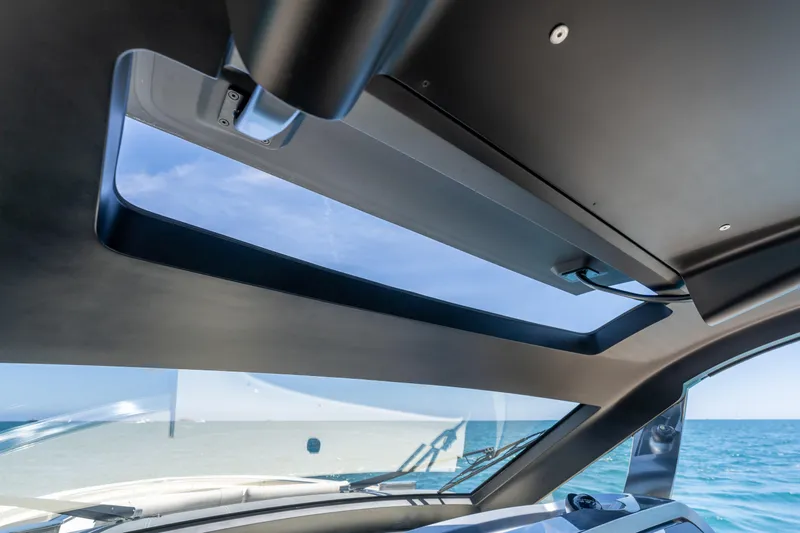 Slide: The Image of Interior view of 2024 Invictus 460 yacht with ocean backdrop through sunroof. - 31
