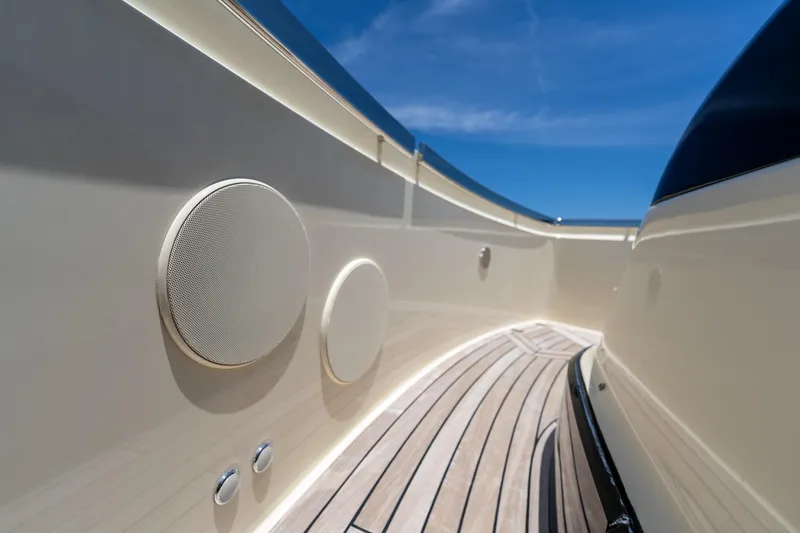 Slide: The Image of Invictus 460 yacht deck with speakers, 2024 model, under clear blue sky. - 33