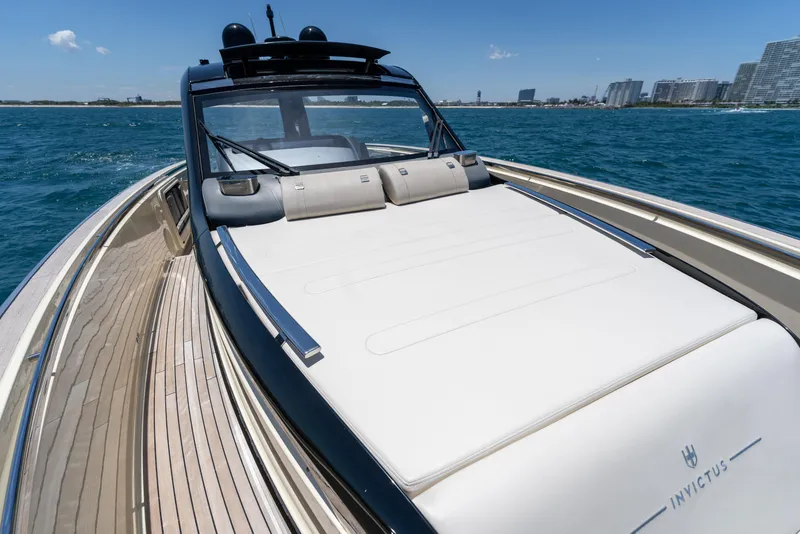 Slide: The Image of 2024 Invictus 460 yacht cruising on blue ocean near city skyline. - 36