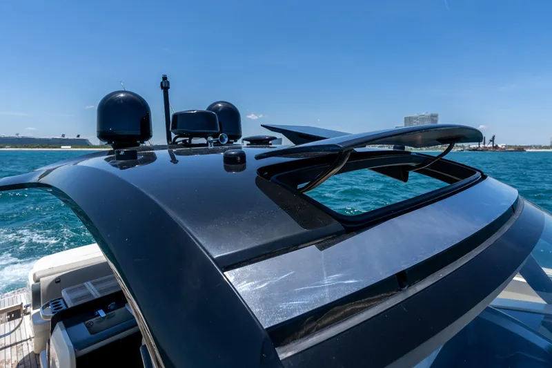 Slide: The Image of Rooftop view of 2024 Invictus 460 yacht with radar equipment on open water. - 38