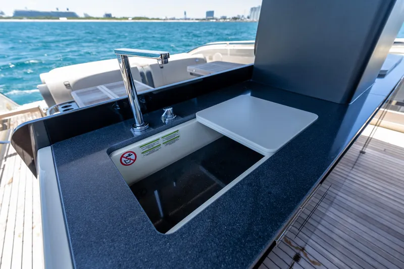Slide: The Image of Luxury yacht Invictus 460 (2024) with sleek outdoor sink and ocean view. - 42