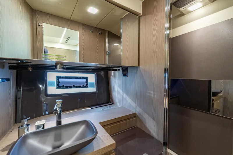 Slide: The Image of Luxurious bathroom interior of 2024 Invictus 460 yacht with modern fixtures and wood accents. - 73