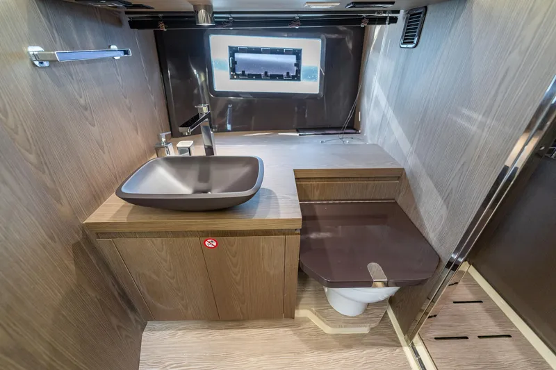 Slide: The Image of Luxurious bathroom interior of 2024 Invictus 460 yacht with modern fixtures and wood finish. - 74