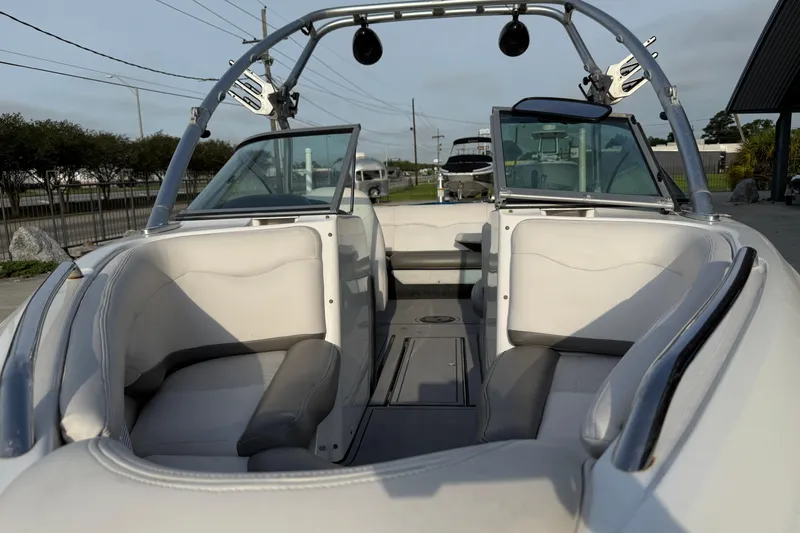 Slide: The Image of 2005 MasterCraft X10 boat interior with white seating and open windshield. - 10