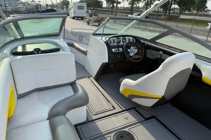 Slide: The Image of Interior of a 2005 MasterCraft X10 boat with white and gray seating. - 11