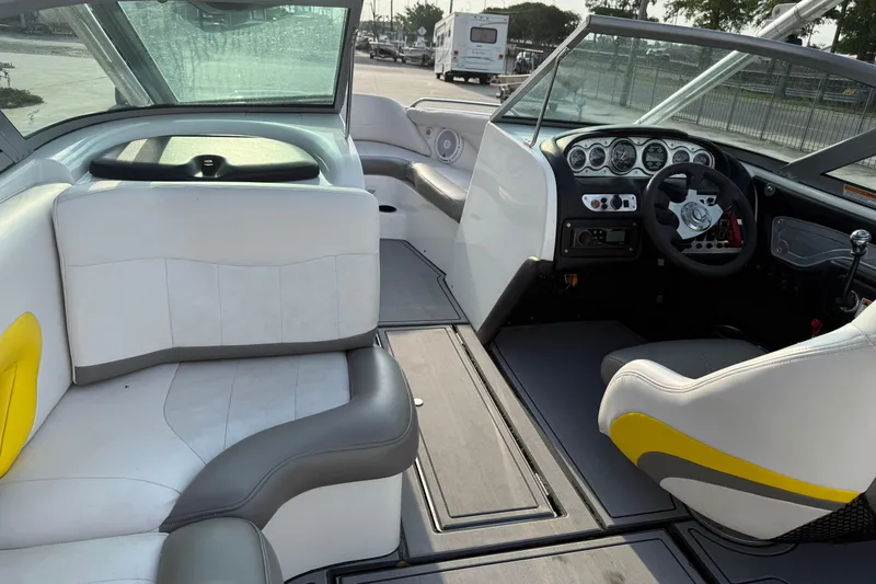 Slide: The Image of Interior of a 2005 MasterCraft X10 boat with white and gray seating. - 13