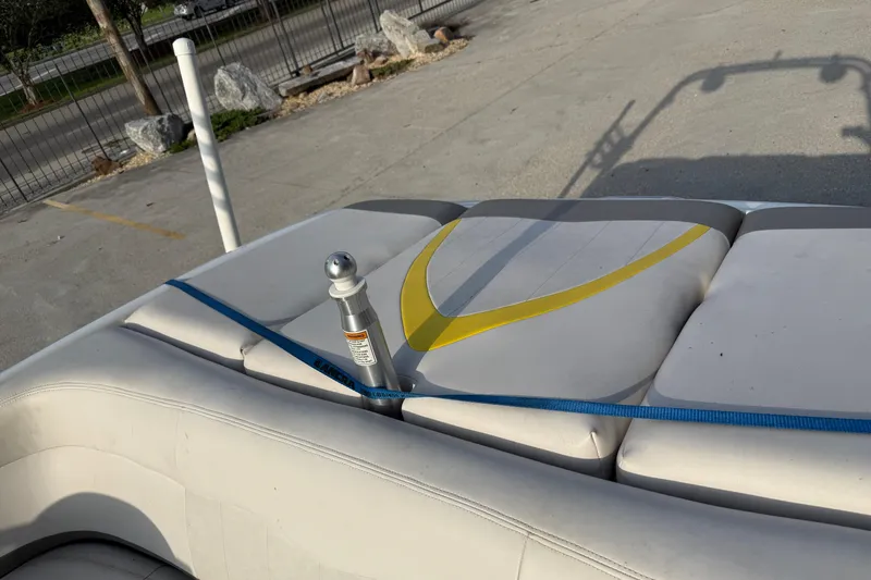 Slide: The Image of 2005 MasterCraft X10 boat interior with white and yellow seating, secured by a blue strap. - 14
