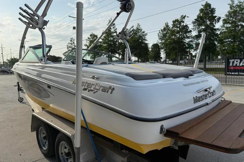 Slide: The Image of 2005 MasterCraft X10 boat on trailer, featuring sleek design and wakeboard tower. - 5