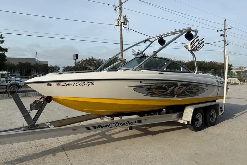 Slide: The Image of 2005 MasterCraft X10 boat on trailer, featuring sleek design and vibrant yellow accents. - 8