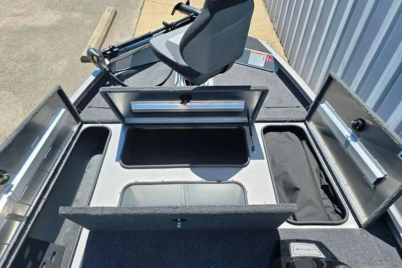 Slide: The Image of 2026 Lowe Stinger 175 boat interior with open storage compartments and seating. - 6