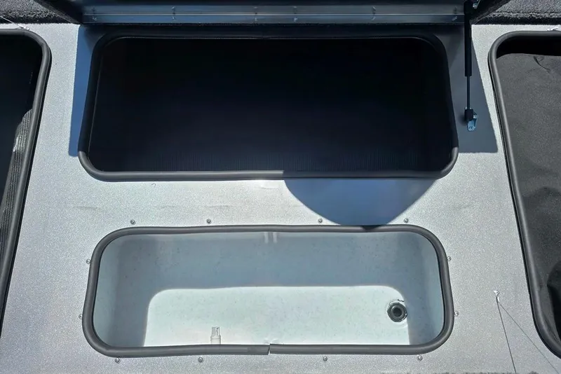 Slide: The Image of Open storage compartments on a 2026 Lowe Stinger 175 boat deck. - 7