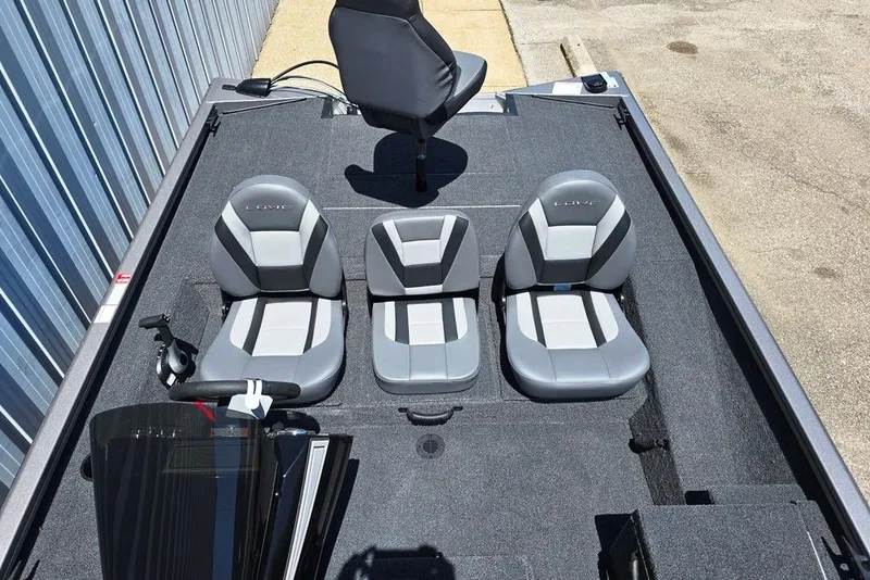 Slide: The Image of 2026 Lowe Stinger 175 boat interior with three gray seats and steering console. - 8
