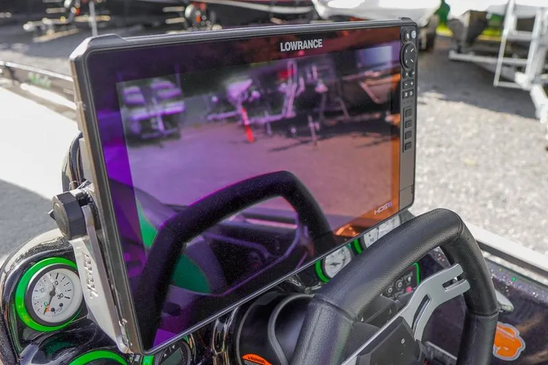 Slide: The Image of 2023 Bass Cat Puma STS dashboard with Lowrance HDS display and gauges. - 11