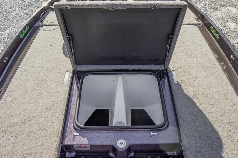 Slide: The Image of 2023 Bass Cat Puma STS boat storage compartment open, showcasing interior space. - 23