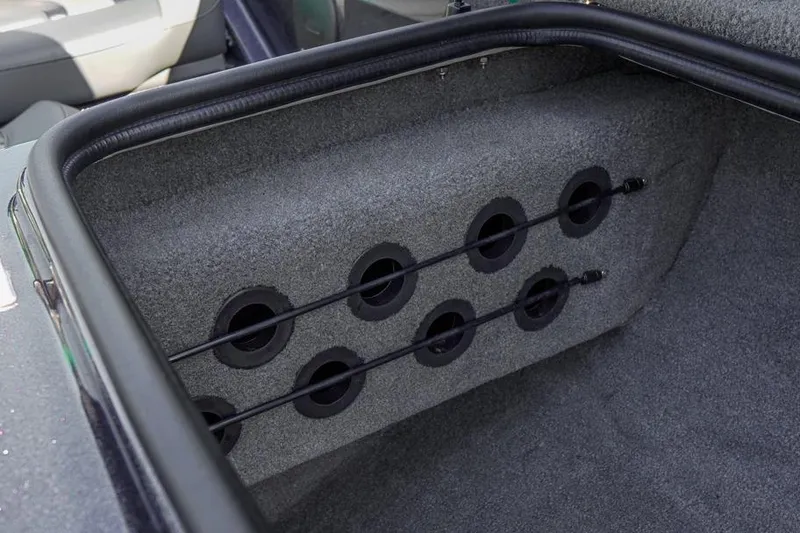 Slide: The Image of 2023 Bass Cat Puma STS rod storage compartment with secure holders and carpeted interior. - 25