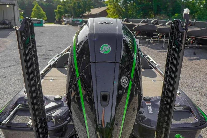 Slide: The Image of 2023 Bass Cat Puma STS boat with sleek black and green design, rear view. - 4