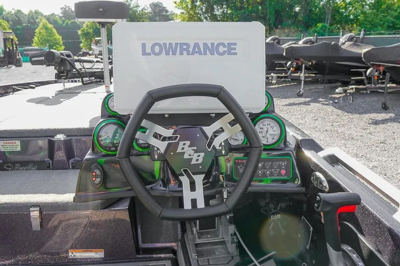 Slide: The Image of 2023 Bass Cat Puma STS boat dashboard with Lowrance electronics and steering wheel. - 7