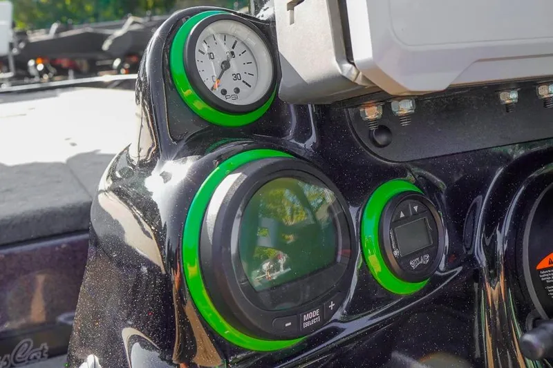 Slide: The Image of 2023 Bass Cat Puma STS dashboard with green-accented gauges and digital display. - 8