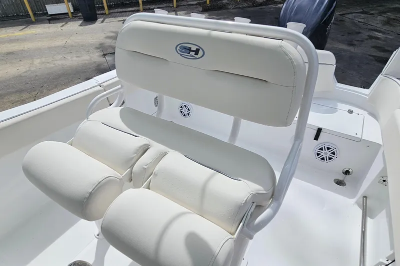 Slide: The Image of 2025 Sea Hunt Ultra 235 SE boat interior with white cushioned seating. - 10