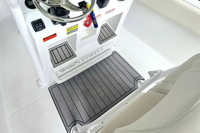 Slide: The Image of Interior view of 2025 Sea Hunt Ultra 235 SE boat cockpit with steering wheel. - 11