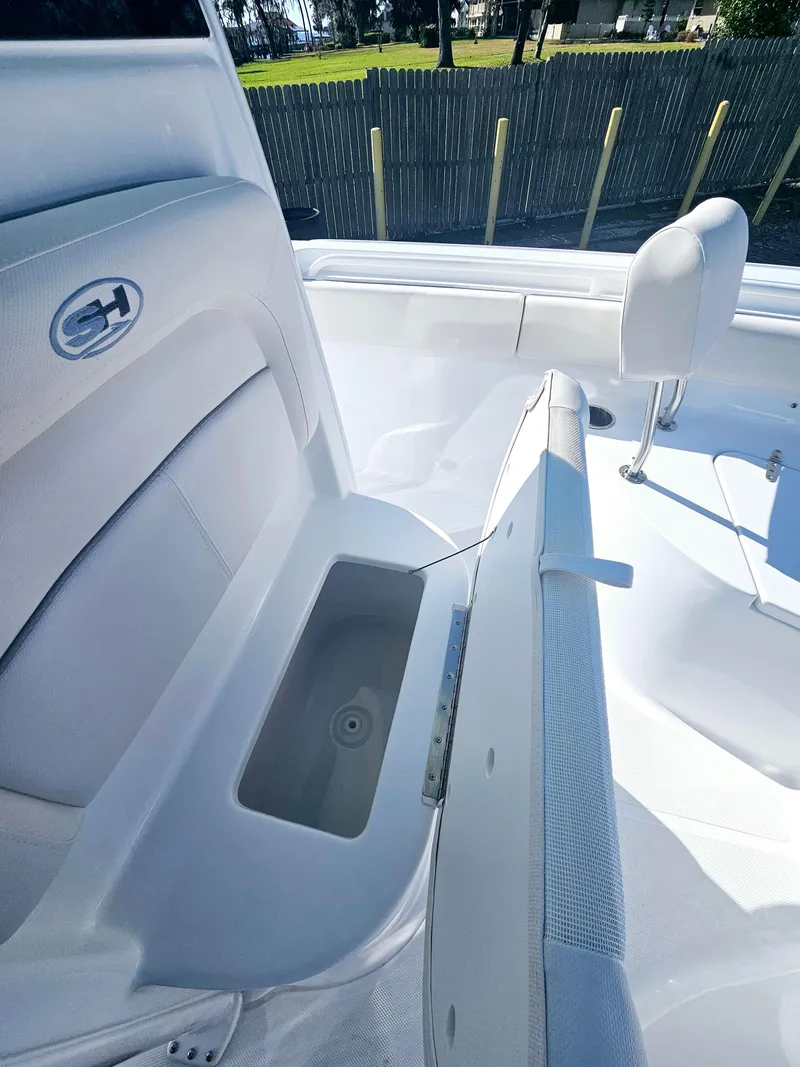 Slide: The Image of 2025 Sea Hunt Ultra 235 SE boat interior with open storage compartment. - 18