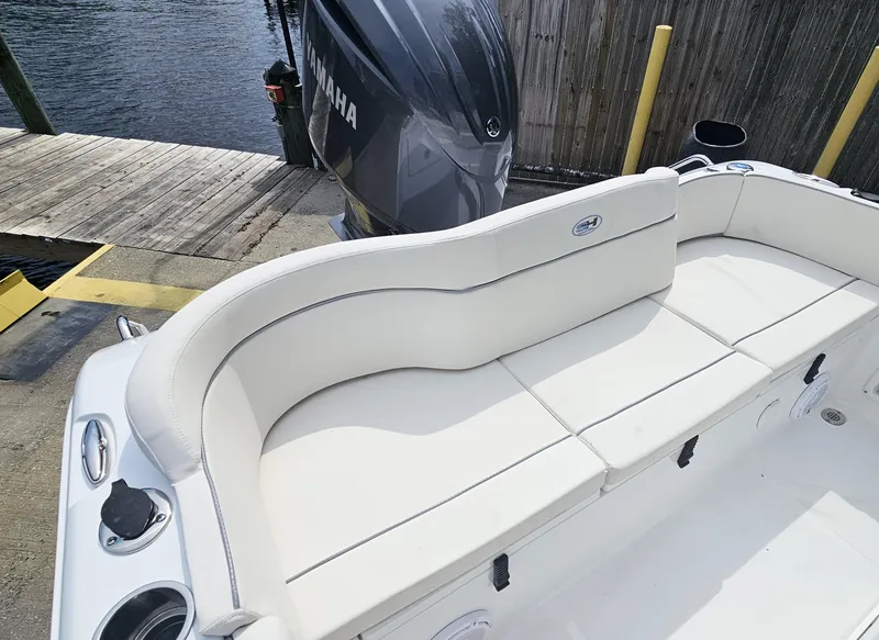 Slide: The Image of 2025 Sea Hunt Ultra 235 SE boat with Yamaha engine, featuring white cushioned seating. - 23