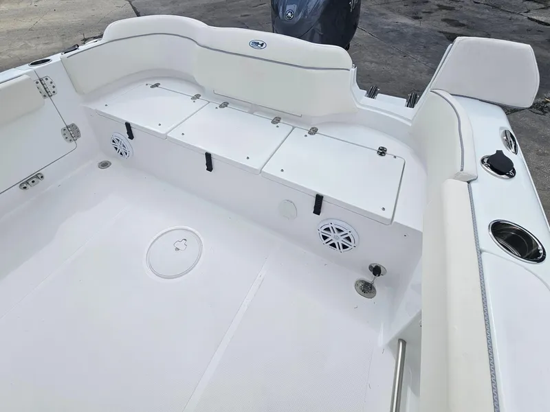 Slide: The Image of 2025 Sea Hunt Ultra 235 SE boat interior with seating and storage compartments. - 24