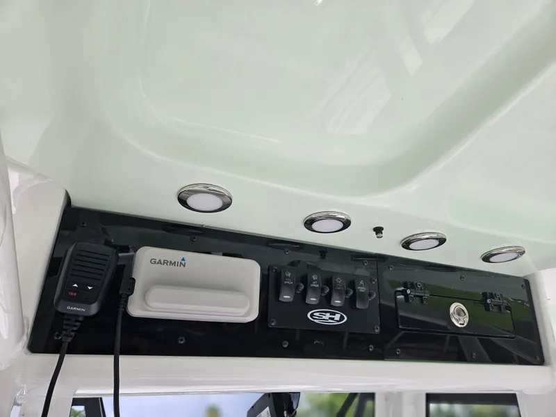 Slide: The Image of 2025 Sea Hunt Ultra 235 SE dashboard with Garmin equipment and control panel. - 27