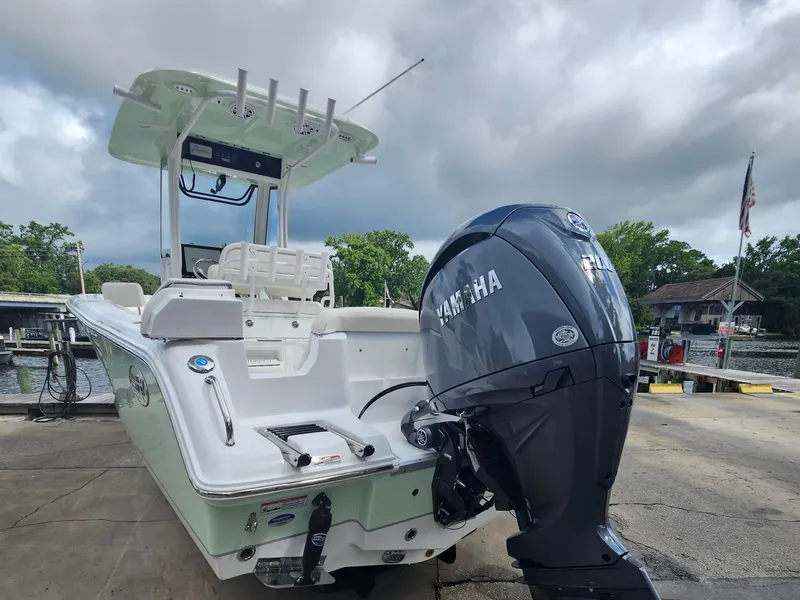Slide: The Image of 2025 Sea Hunt Ultra 235 SE boat with Yamaha engine at dockside. - 3