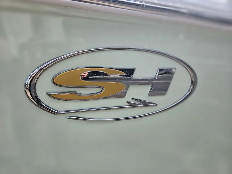 Slide: The Image of Sea Hunt Ultra 235 SE 2025 logo emblem on boat exterior. - 5