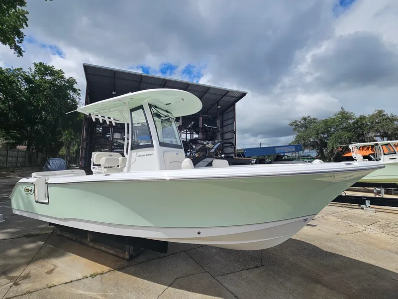 Slide: The Image of 2025 Sea Hunt Ultra 235 SE boat in a marina setting under cloudy skies. - 8