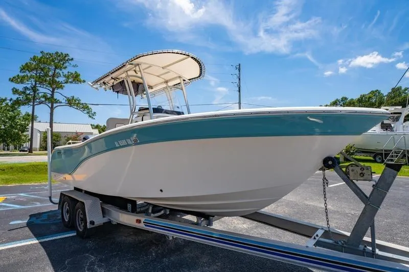 Slide: The Image of 2021 Sea Fox 228 Commander boat on trailer under clear blue sky. - 14