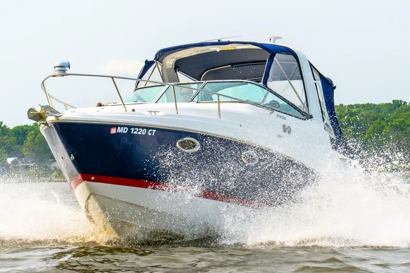 Slide: The Image of 2018 Rinker EX 270 boat cruising on water, creating splashes. - 29