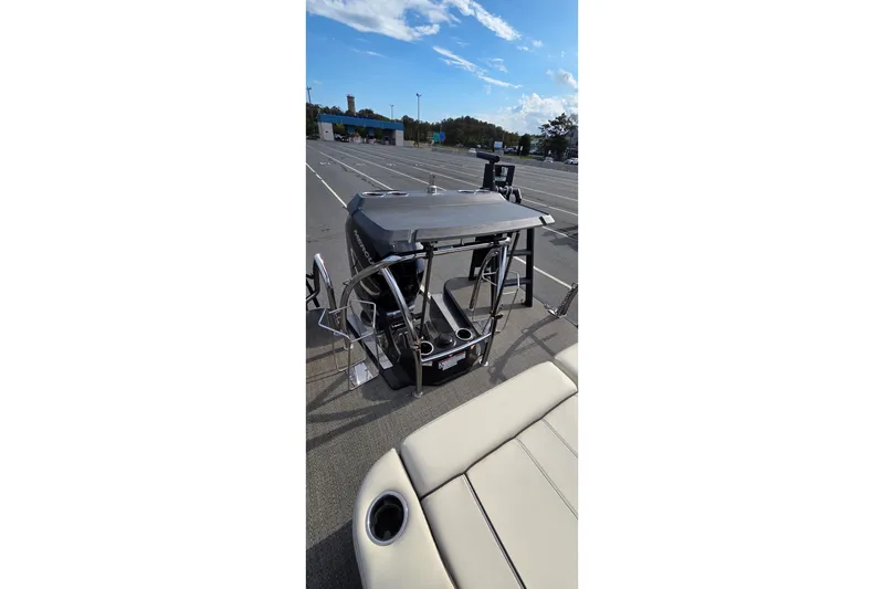 Slide: The Image of 2025 Barletta Lusso 25UCA pontoon boat with sleek design in a parking lot. - 10