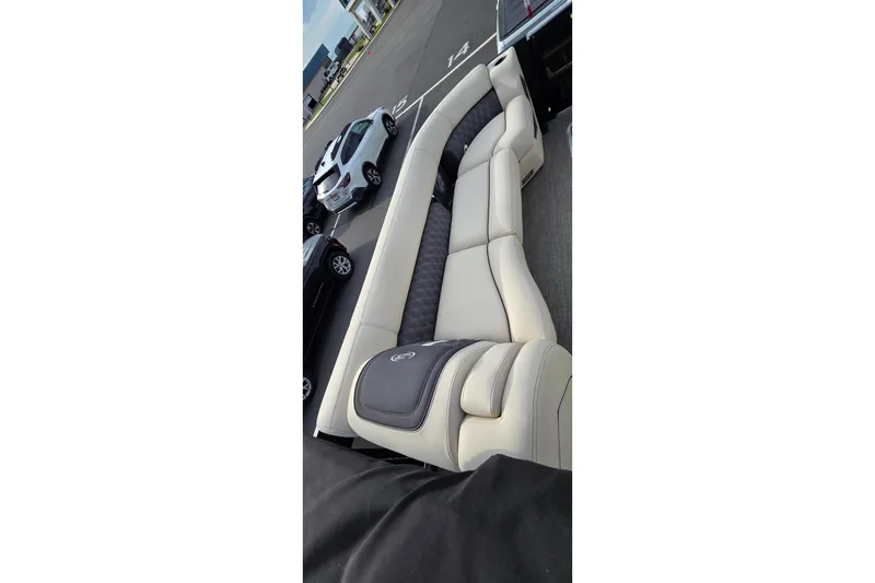 Slide: The Image of Luxurious seating on 2025 Barletta Lusso 25UCA pontoon boat, parked in a lot. - 12